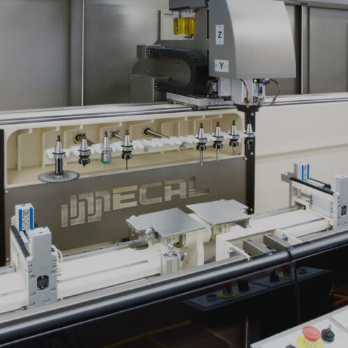 Close up image of a Mecal CNC machining center showing the tool magazine and clamping system for machining aluminium profiles.